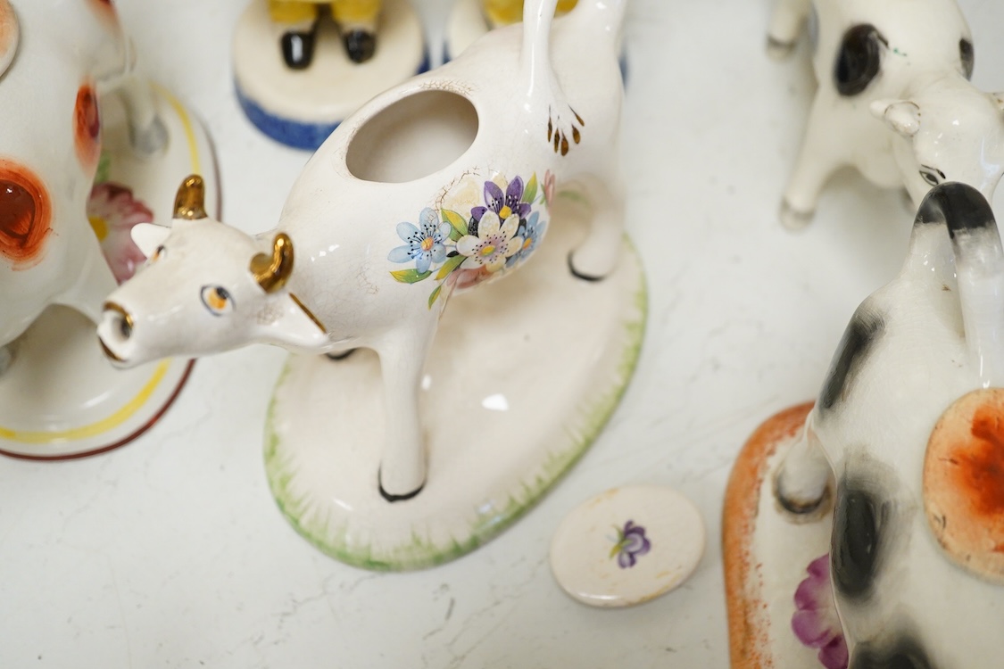 A large collection of English pottery cow creamers, Staffordshire figures and cruets a blue and white teapot and sponge ware dish-34cm diameter, (26)